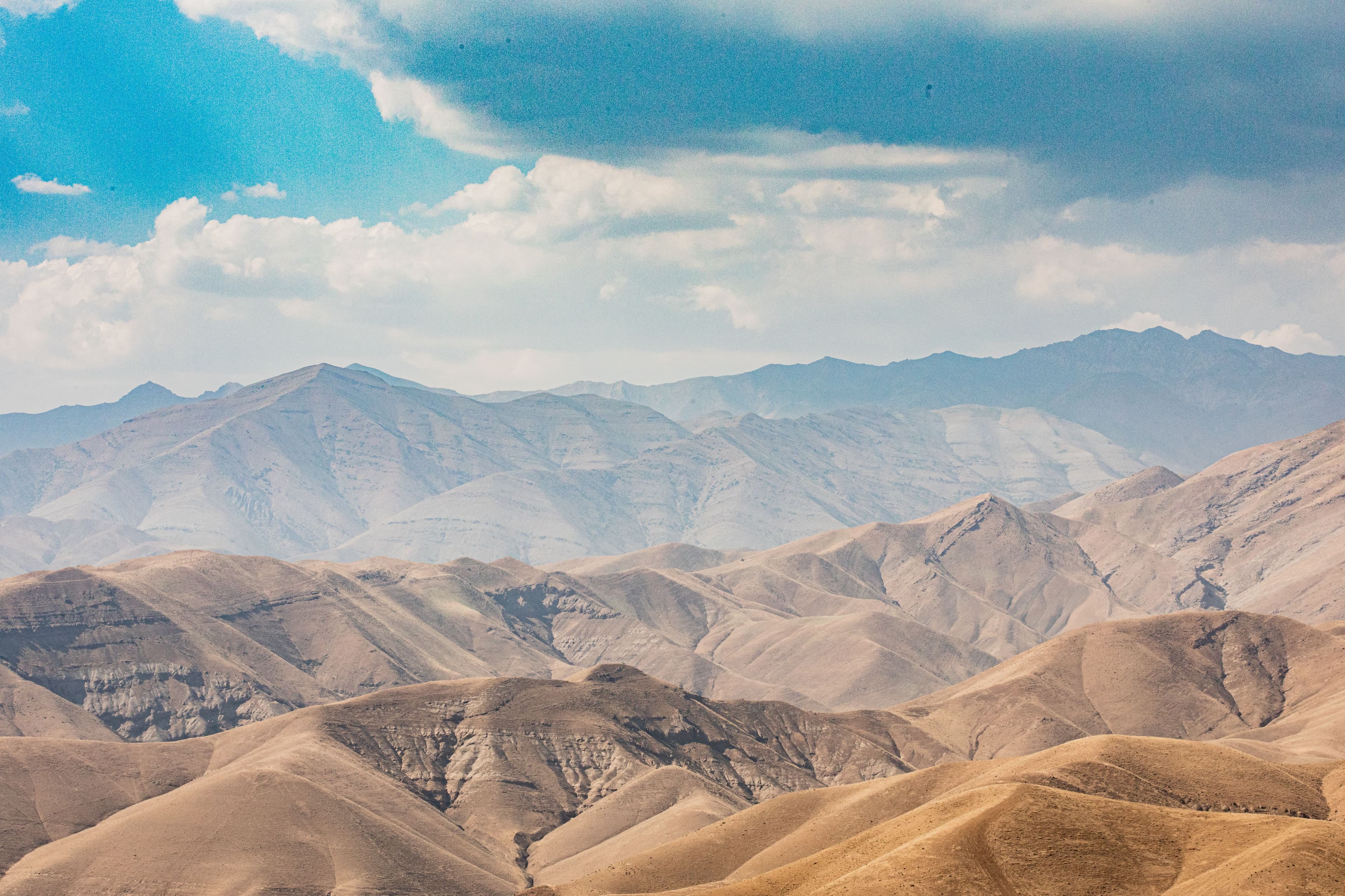 Blue desert mountain ridges under a heavy cloud